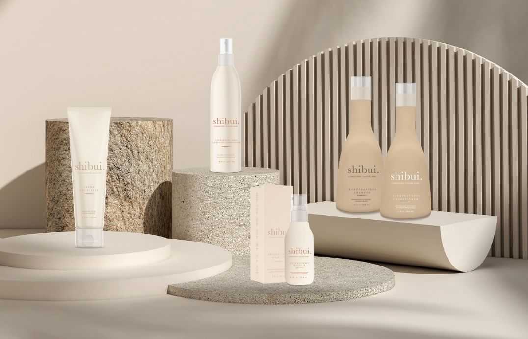 Minimalist skincare product display with bottles and tubes on stone-like platforms.